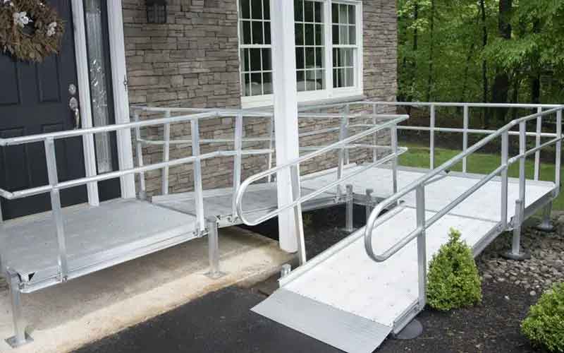 Rampe d'accès handicapé installée devant une entrée de logement